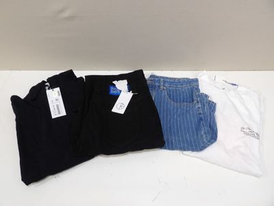 three pairs of black, white, and blue jeans sitting on a table