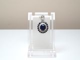 silver and blue stone earrings on clear acrylic display stand