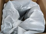 a cardboard box filled with a bag of plastic material