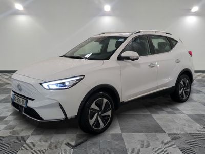 a white suv parked in a room with checkered floor