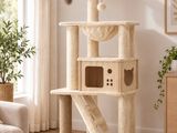 the cat is sitting on top of the cat tree in the living room