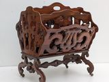 a wooden magazine holder with a carved design on it