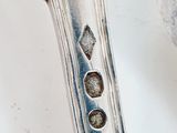 an image of a silver spoon on a table with a spoon in the middle