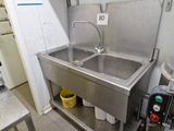 two sinks in the kitchen with a faucet on the counter