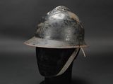 an old fireman ' s helmet on a mannequin head on a black background