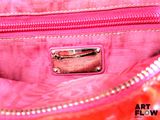 an image of a close up of a pink purse with a metal buckle