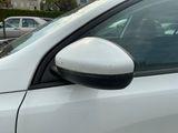 a white car parked in a parking lot with other cars in the background