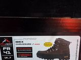 someone is holding a box with a pair of hiking boots in it