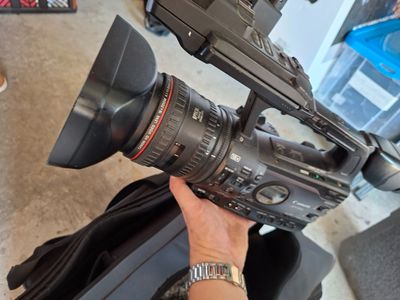 a person holding a video camera in their hand