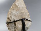 a close up of a rock on a metal stand on a gray background