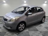 a picture of a small silver car in a room