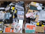 a cardboard box full of electronic devices and other items