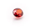 a red garnet stone on a white background