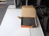 a box that has a gun in it on a table