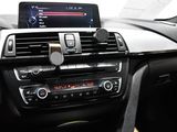 the dashboard of a car with a tablet in the center of it