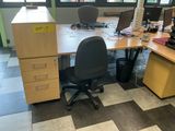 a desk with a chair and a computer on it