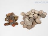 two piles of coins sitting next to each other on a white surface