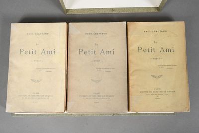 three books sitting on top of a table next to a box