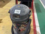 a vacuum that is sitting on the floor in a room
