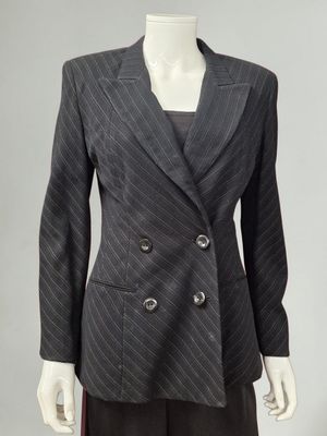 a woman ' s jacket and skirt suit on a mannequin mannequin mannequin mannequin mannequin mannequin mannequin mann