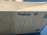 a piece of wood with writing on it sitting on a table