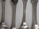 five spoons that are lined up next to each other