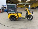 a yellow scooter with a box on the back of it