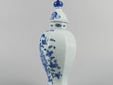 blue and white vase with a lid with a flower design on it