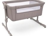 a close up of a baby crib with a white sheet in it