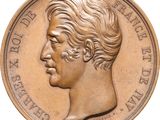 une image représentant une médaille de bronze sur laquelle figure le visage d'un homme