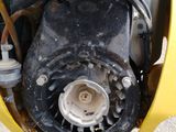 a close up of the engine of a yellow motorcycle