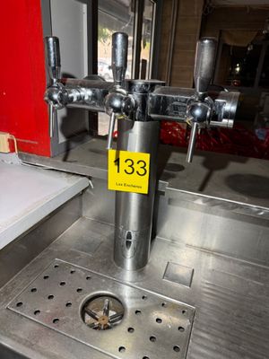 a stainless steel sink with a metal faucet on top of it