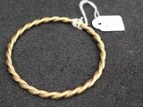 a close up of a rope bracelet with a tag on it