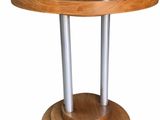 a wooden table with two metal poles on top of it