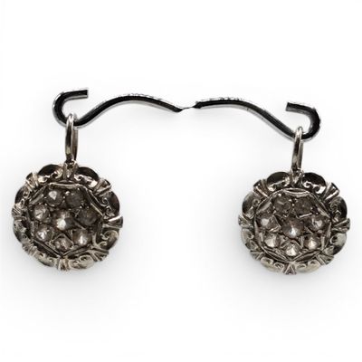 pair of antique silver earrings with diamonds on a white background