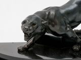 a bronze statue of a panther on a black base