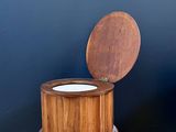 a wooden box with a lid sitting on a wooden floor