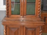 a wooden cabinet with a glass door on top of it