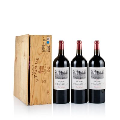 trois bouteilles de vin rouge devant une caisse en bois