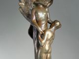 bronze statue of a woman holding a large bowl on her head