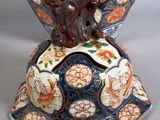 a vase that has a bird on top of it