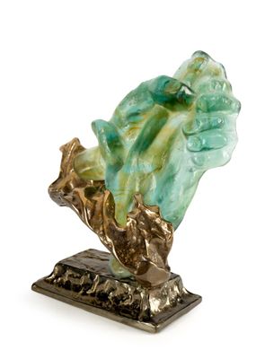 statue of a hand holding a leaf on a base