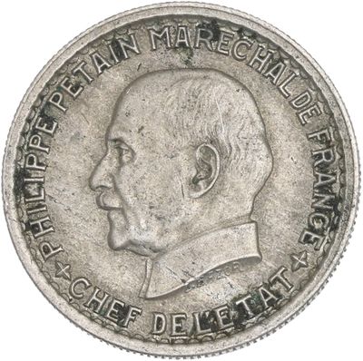 a close up of a silver coin with a man ' s face on it