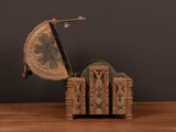 a small clock that is sitting on a wooden table