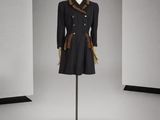 une photo d'un mannequin vêtu d'un manteau noir et d'une écharpe marron