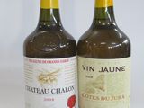 two bottles of wine sitting next to each other on a table