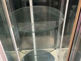 a glass display case with three glass shelves inside of it