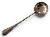 a silver spoon with a spoon handle on a white surface