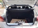 a white car with its trunk open and a box in the trunk
