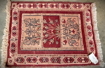 a close up of a rug on a floor with a tag on it